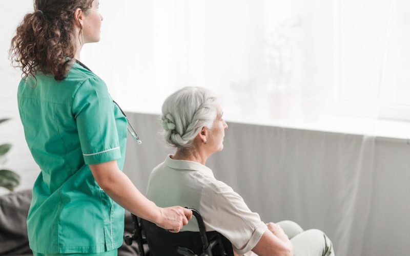 citiio-side-view-nurse-pushing-disabled-patient-wheel-chair_23-2147861489