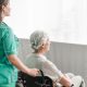 citiio-side-view-nurse-pushing-disabled-patient-wheel-chair_23-2147861489